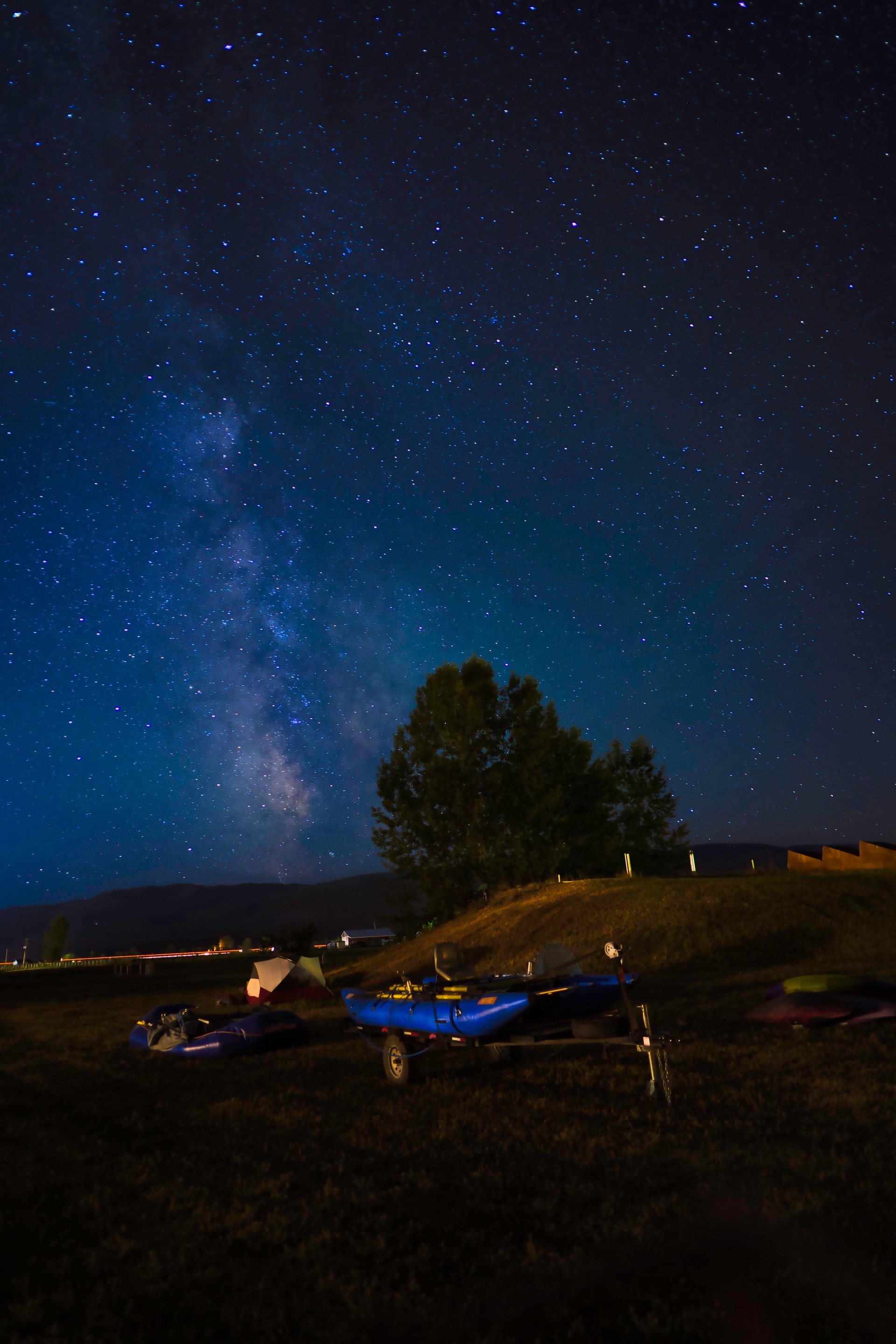 The Milky Way rising above a dark rural landscape in Montana